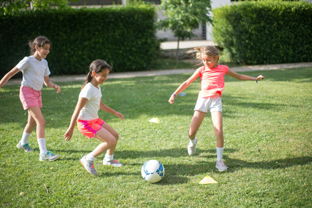 girls playing soccer as a part of adventure therapy