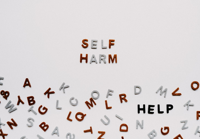 letters spelling self-harm and help